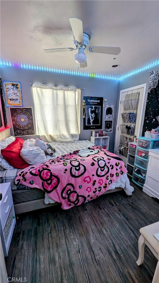 bedroom featuring ceiling fan and dark hardwood / wood-style flooring