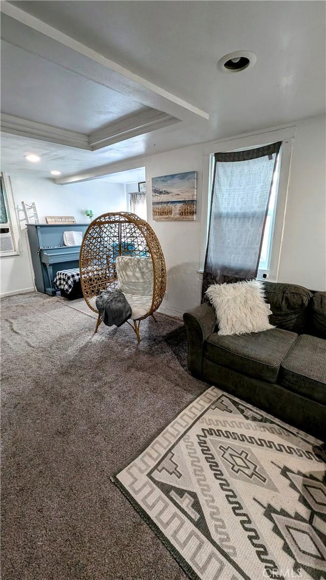 living room with a raised ceiling, crown molding, and carpet floors