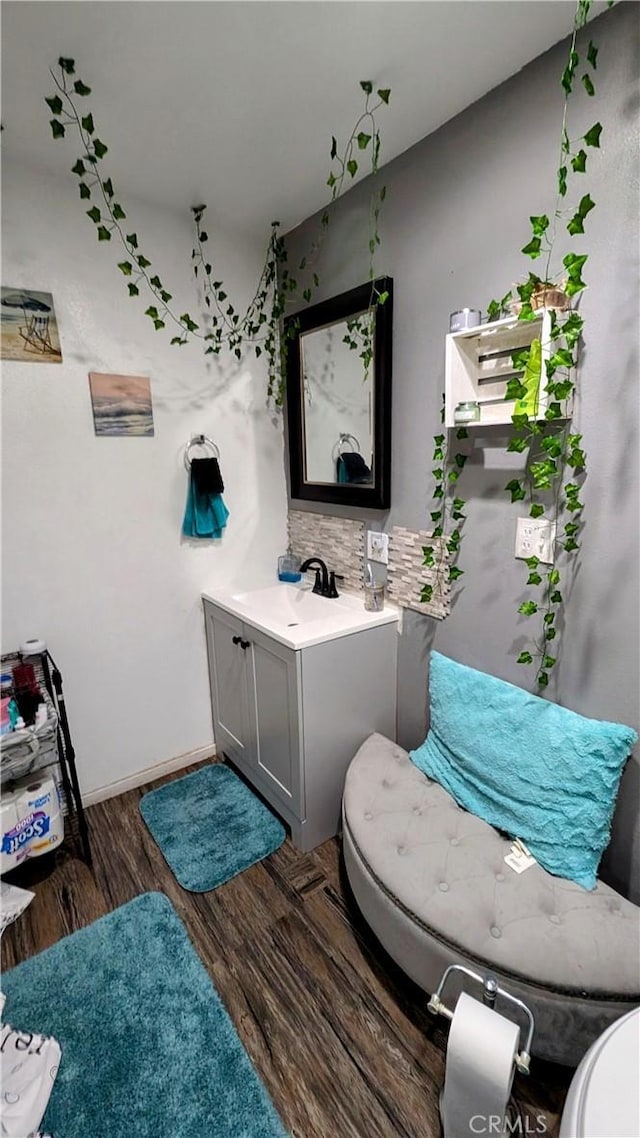 bathroom with vanity, hardwood / wood-style flooring, and toilet