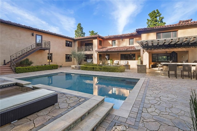 view of swimming pool with a patio area and exterior bar