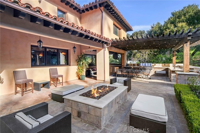 view of patio featuring a pergola, area for grilling, an outdoor living space with a fire pit, and exterior bar