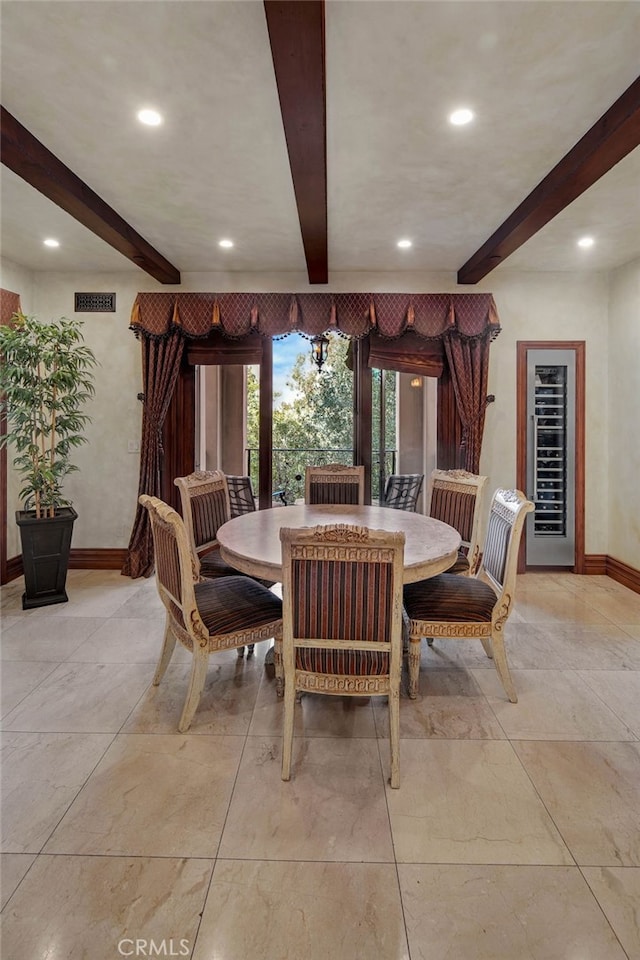 dining space featuring beamed ceiling