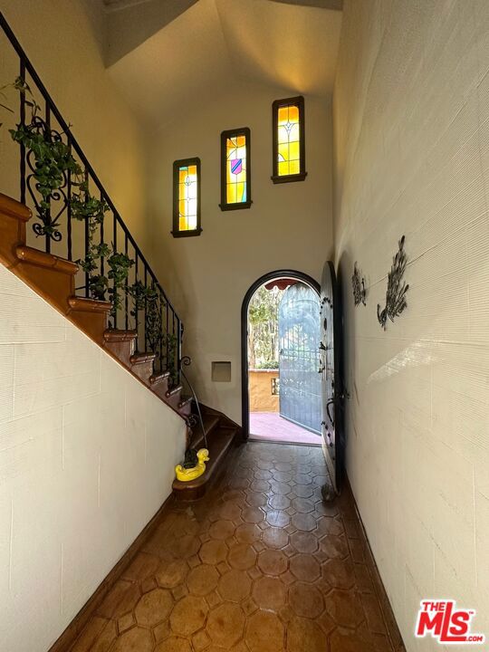 tiled foyer entrance with lofted ceiling and plenty of natural light