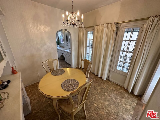 dining space featuring a notable chandelier and vaulted ceiling