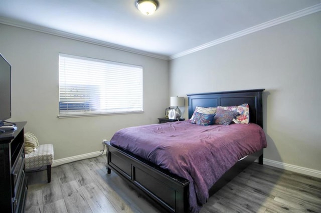 bedroom with hardwood / wood-style floors and ornamental molding