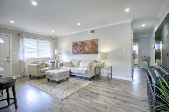 living room featuring light hardwood / wood-style floors and ornamental molding