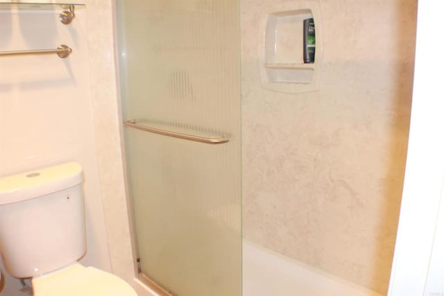 bathroom featuring an enclosed shower and toilet