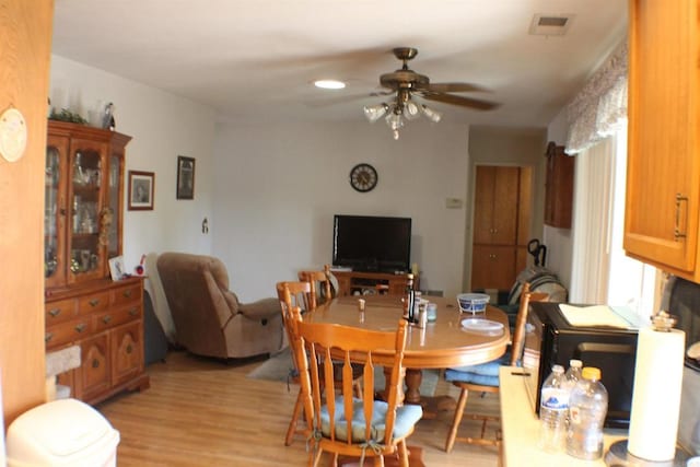 dining area featuring light hardwood / wood-style floors and ceiling fan