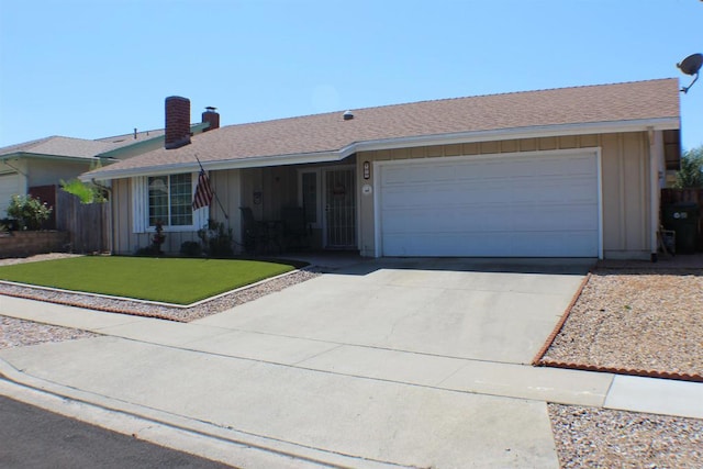 single story home with a front yard and a garage