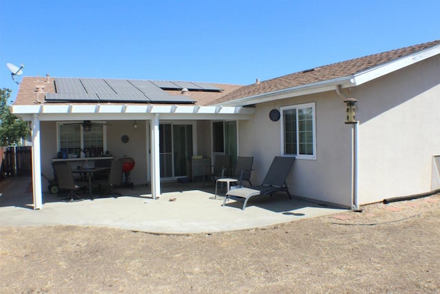 back of property featuring ceiling fan and a patio area