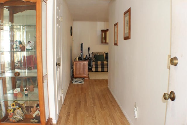 hall with light hardwood / wood-style floors