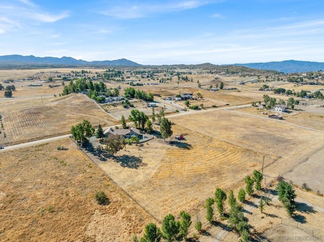 drone / aerial view with a mountain view and a rural view