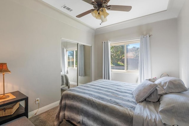 carpeted bedroom featuring ceiling fan and a closet