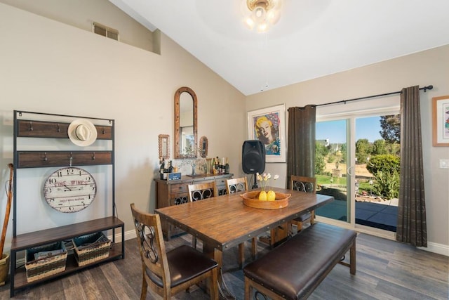 dining space with high vaulted ceiling and dark wood-type flooring