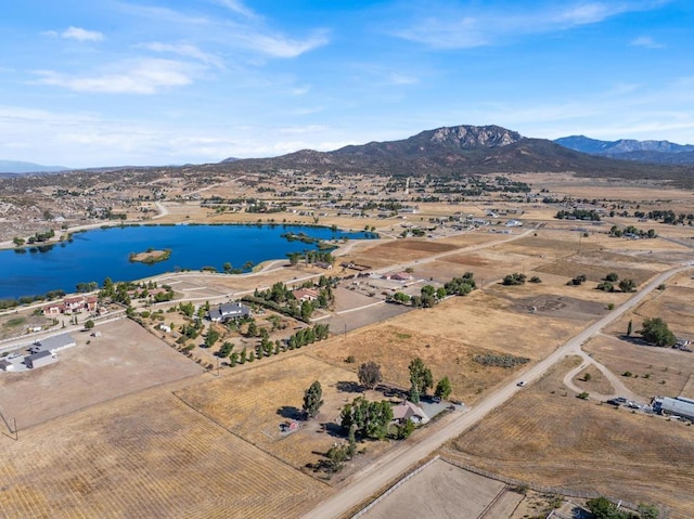 drone / aerial view featuring a water and mountain view