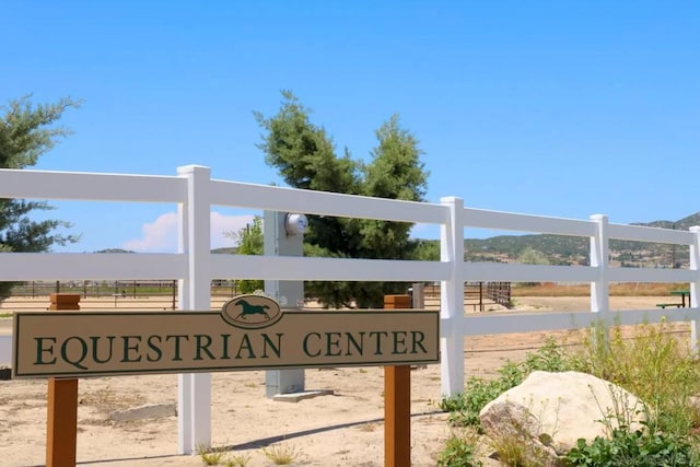 community / neighborhood sign with a mountain view