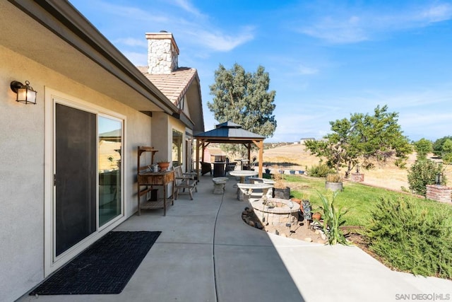 view of patio / terrace with a gazebo and a fire pit