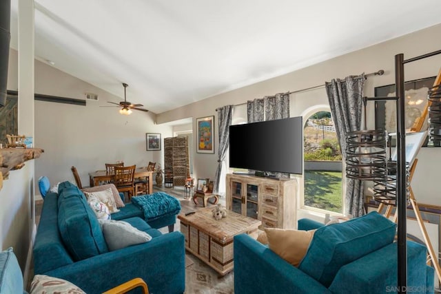 living room featuring ceiling fan and lofted ceiling