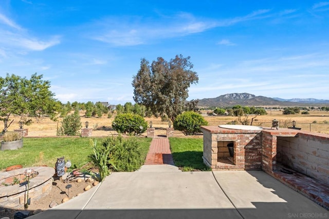 view of patio with a mountain view and a rural view