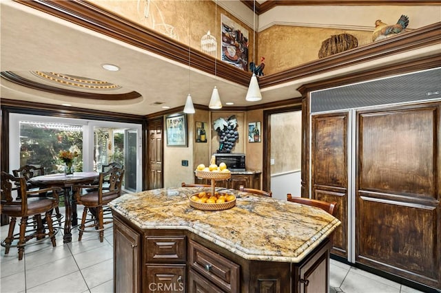 kitchen with crown molding, hanging light fixtures, and a center island