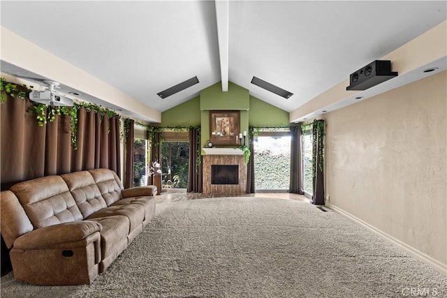 unfurnished living room featuring vaulted ceiling with skylight, a tile fireplace, and carpet flooring