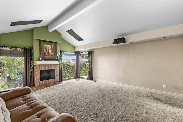 carpeted living room featuring vaulted ceiling with beams and a fireplace