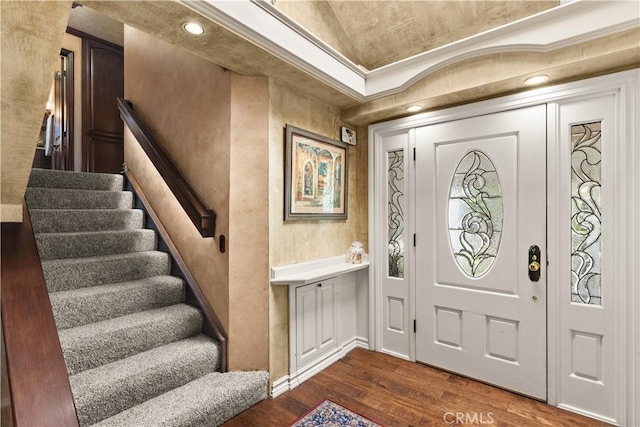 foyer entrance featuring dark hardwood / wood-style flooring and ornamental molding