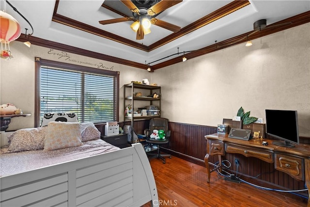 bedroom with ceiling fan, a tray ceiling, and ornamental molding