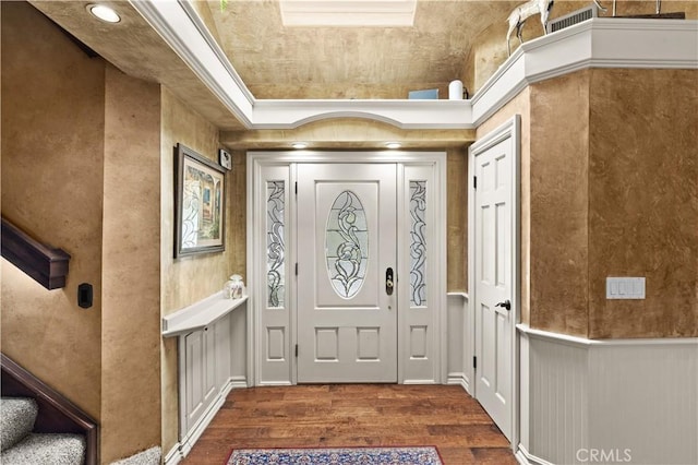 entryway with dark hardwood / wood-style flooring and ornamental molding