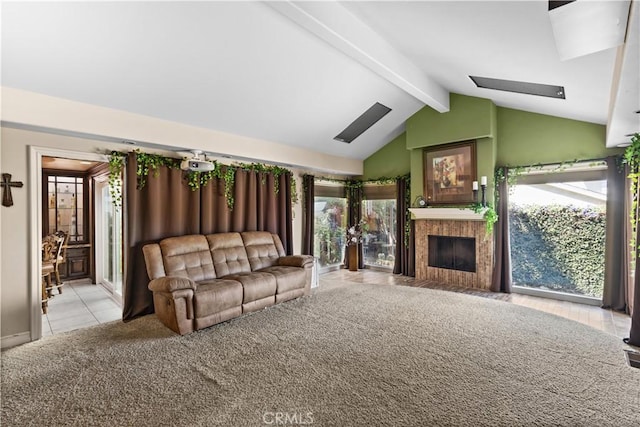 carpeted living room with a fireplace and lofted ceiling with beams