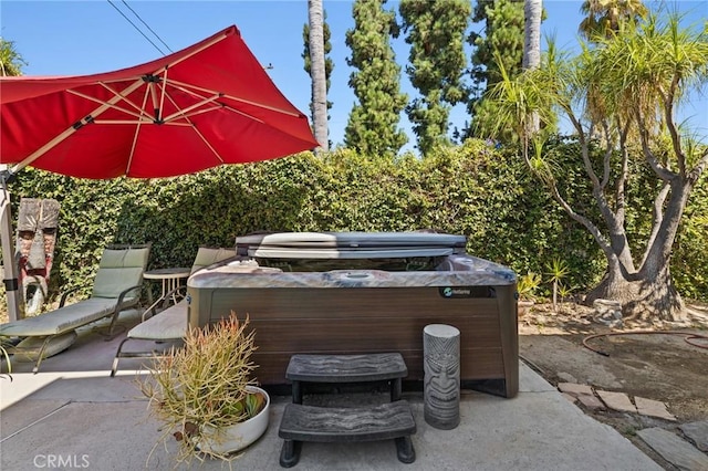 view of patio / terrace with a hot tub