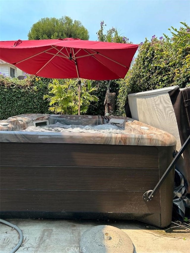 view of pool with a hot tub