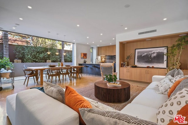 living room with floor to ceiling windows and sink