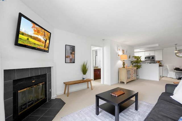 living room with dark carpet and a fireplace