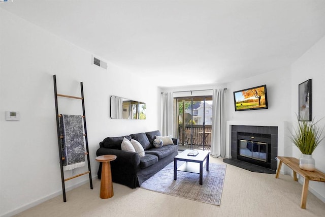 living room with a fireplace and light colored carpet