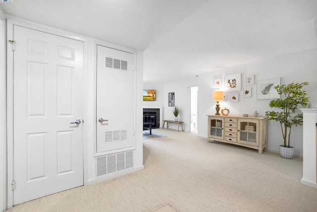 interior space with carpet floors and a fireplace