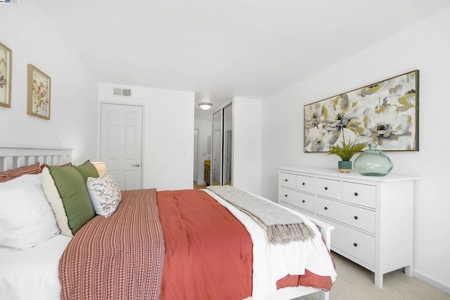 bedroom featuring light carpet