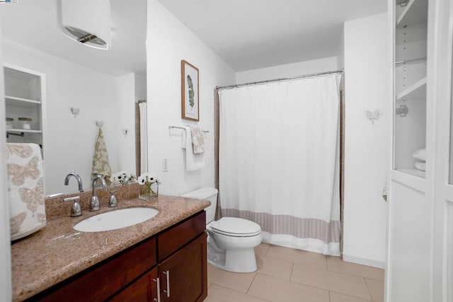 bathroom with vanity, toilet, and tile patterned floors