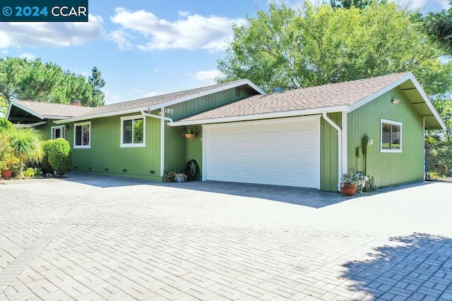 ranch-style home featuring a garage