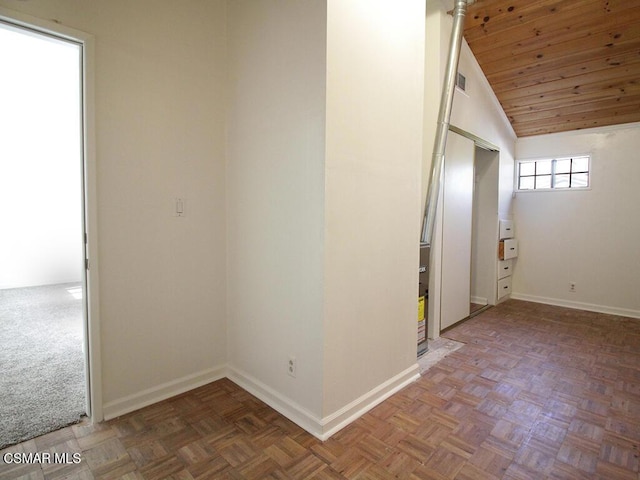 unfurnished room featuring parquet floors, wood ceiling, and vaulted ceiling