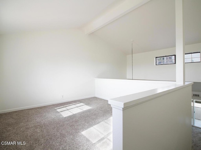 carpeted spare room with lofted ceiling with beams