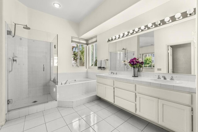 bathroom with tile patterned floors, vanity, and separate shower and tub