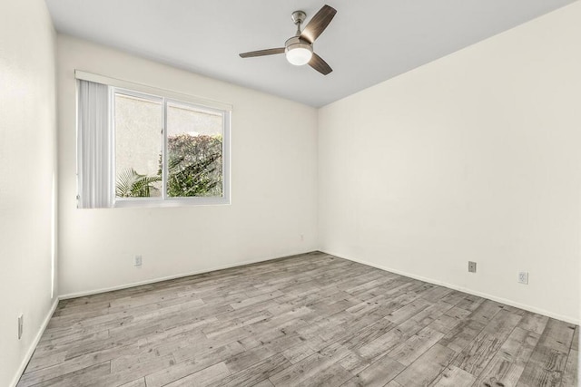 empty room featuring ceiling fan and light hardwood / wood-style flooring