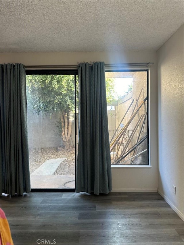 room details featuring wood-type flooring and a textured ceiling