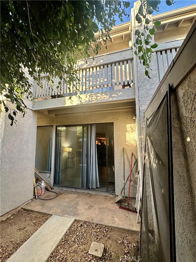 back of house featuring a patio and a balcony