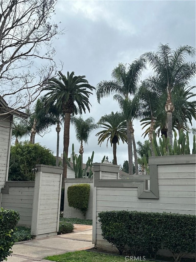 community / neighborhood sign with fence and a gate