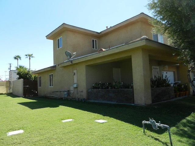 rear view of property featuring a yard