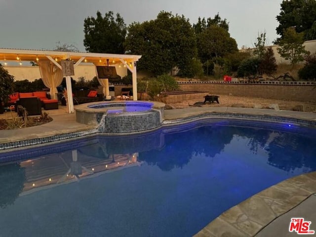 view of pool with a patio and an in ground hot tub