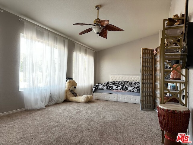 bedroom featuring carpet floors, lofted ceiling, and ceiling fan