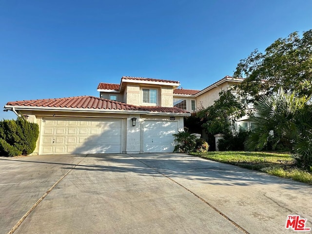 mediterranean / spanish home with a garage